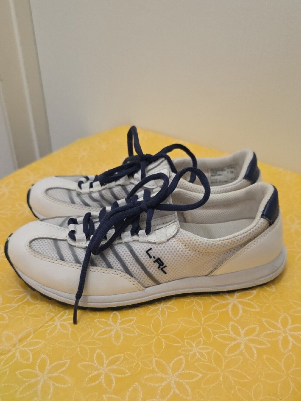 Polo Ralph Lauren sneakers feature navy blue laces and mesh